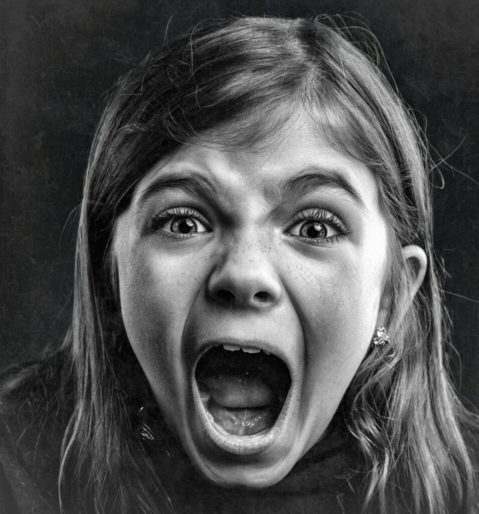 A dramatic girl shouting with emotion and intensity.